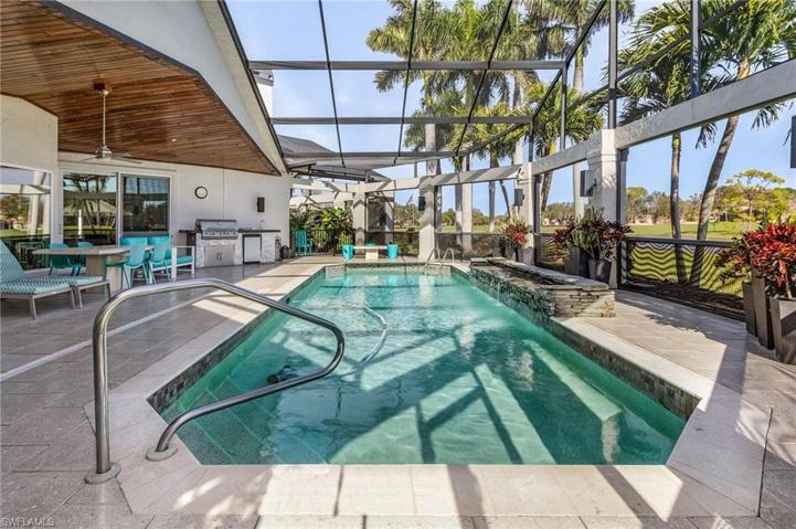 Large, screened in pool area with water feature.