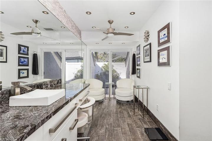 Master bath features dual sinks, granite tops, tile floors, sliders out to the above ground spa and built-in fire pit.