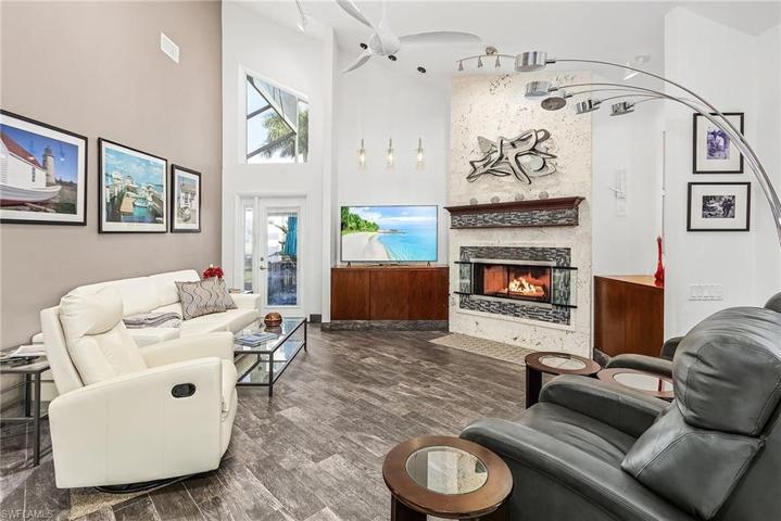Open great room with gas fireplace, built-ins, vaulted ceiling.