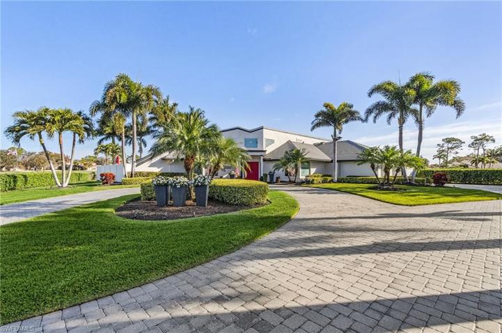 Custom built home with circular paver drive, lush landscaping, nice curb appeal.