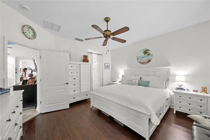 This room features dark wood flooring and white walls, creating a clean aesthetic