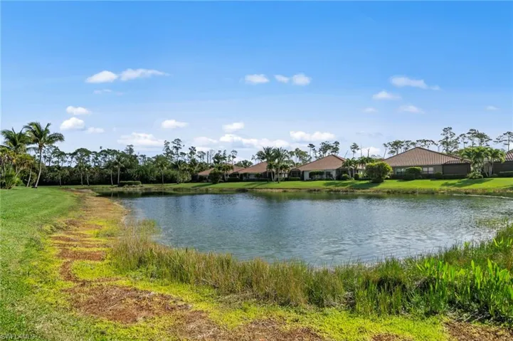 The property offers serene water views, with a clear blue sky overhead