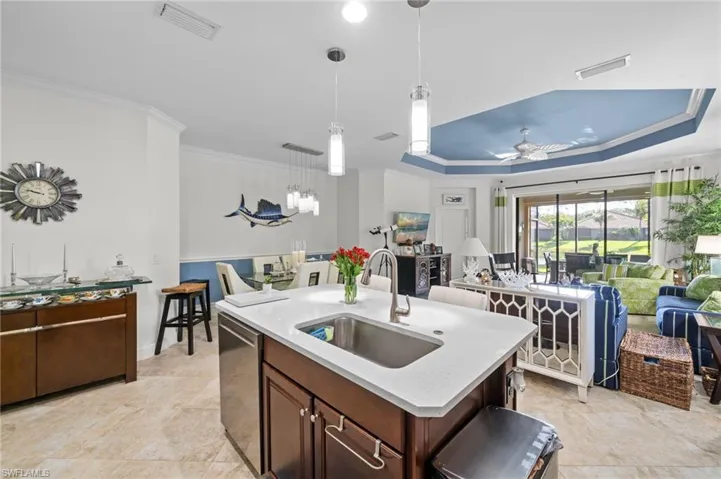 The kitchen features a center island with a sink and a light-colored countertop