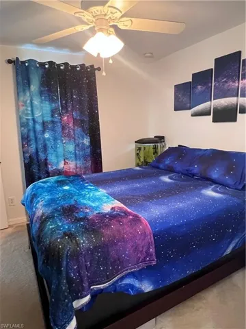 Carpeted bedroom with ceiling fan