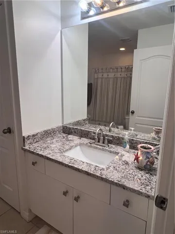 Bathroom featuring tile patterned floors, toilet, and vanity