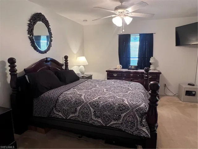 Bedroom with light colored carpet and ceiling fan