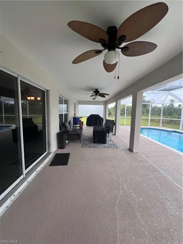 View of patio / terrace featuring a lanai, ceiling fan, and an outdoor hangout area