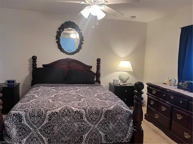 Bedroom featuring ceiling fan and light carpet