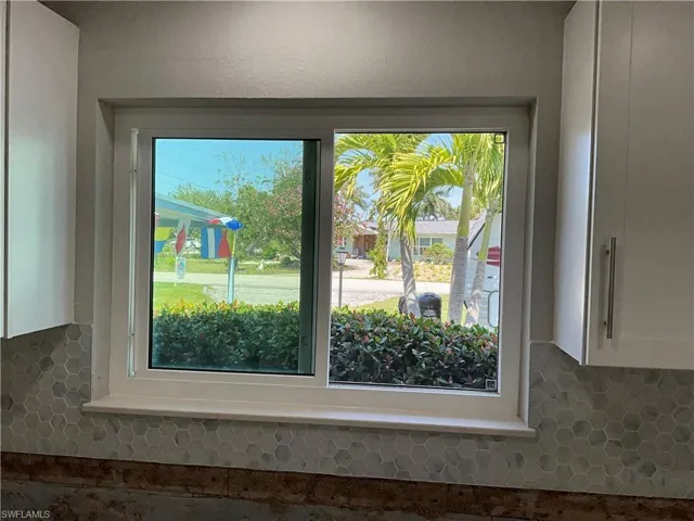 Large kitchen window and with great view and light for cooking & sink.  And new neutral back splash.