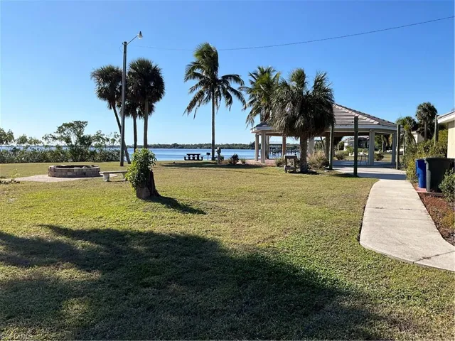 Community Waterfront Park for family and community events featuring a gazebo, a water view, and an outdoor fire pit.  FUN FUN FUN. An exceptional and rare community feature!!!