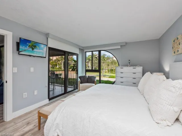 Bedroom with light wood finished floors and access to exterior