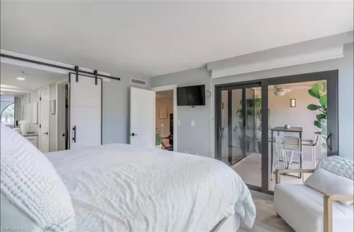 Bedroom with a barn door and access to outside