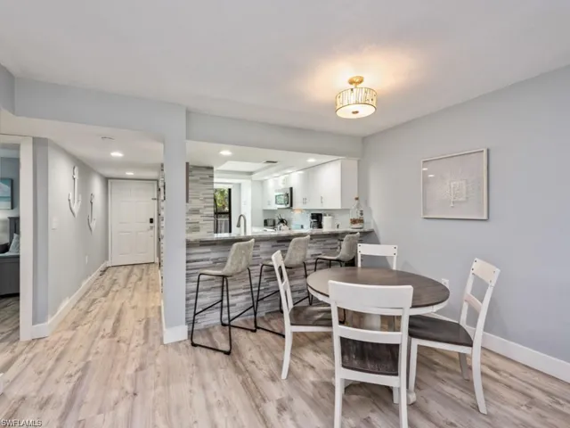 Dining room featuring light wood-style flooring and recessed lighting