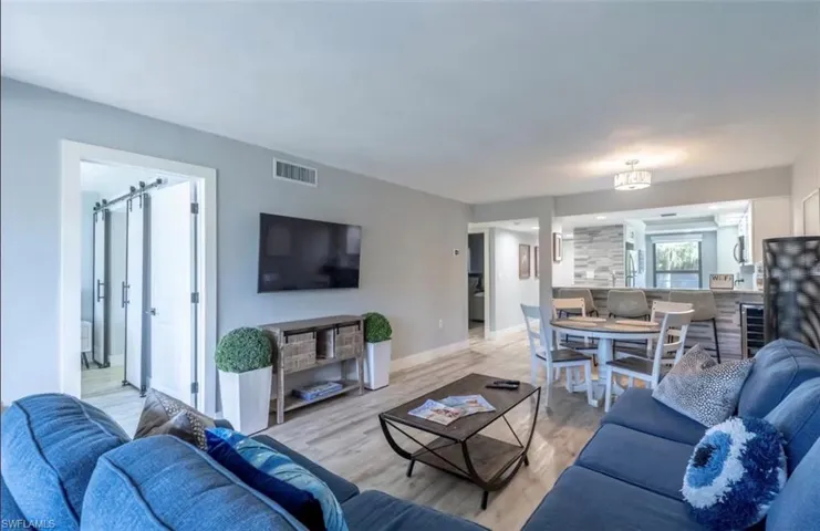 Living area with wood finished floors and wine cooler