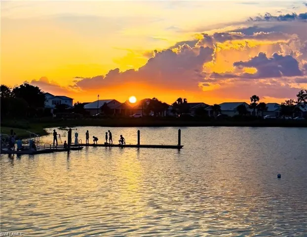 Water view featuring a boat dock and nearby suburban area