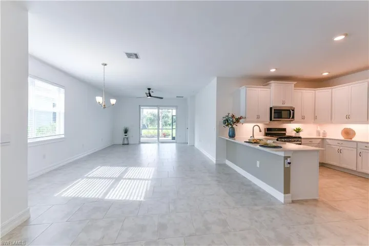 Kitchen with a ceiling fan, appliances with stainless steel finishes, plenty of natural light, open floor plan, and recessed lighting