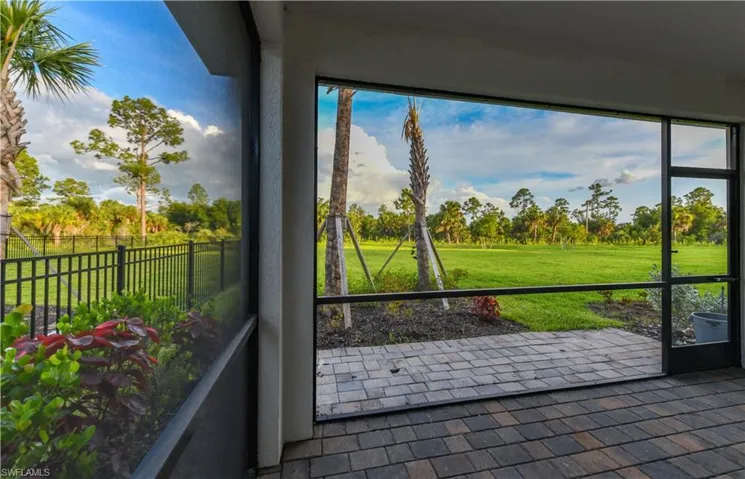 Unfurnished sunroom featuring view of wooded area and healthy amount of natural light