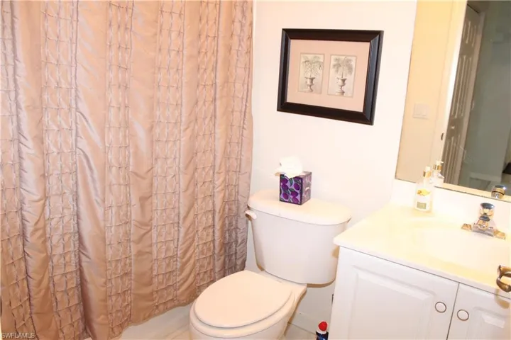 Full bath with a shower with shower curtain and vanity