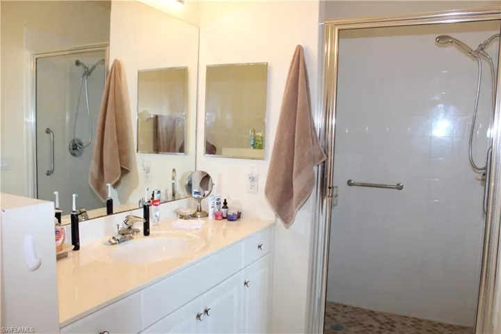 Bathroom featuring vanity and a stall shower