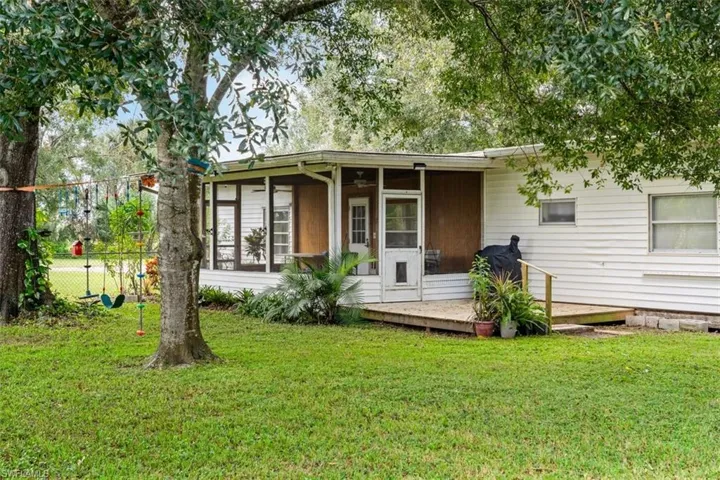 Back of property with a yard