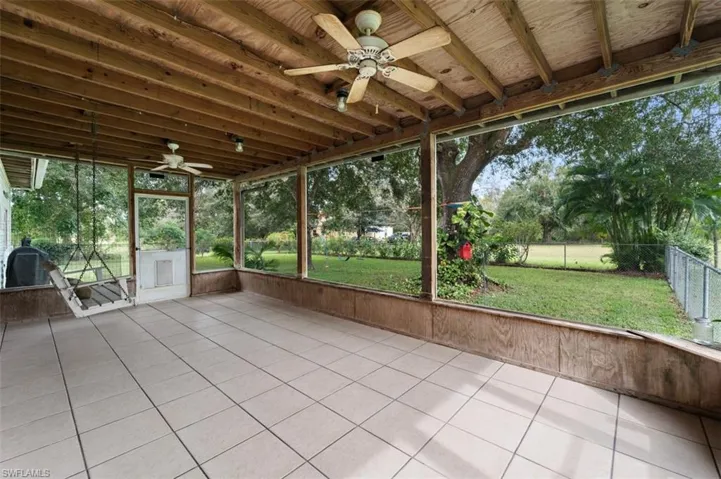 Unfurnished sunroom featuring ceiling fan