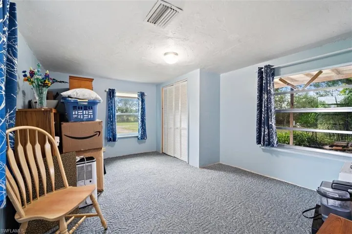 Sitting room with a textured ceiling and carpet flooring