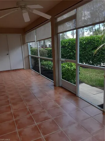 Unfurnished sunroom featuring ceiling fan