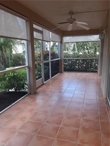 Unfurnished sunroom featuring ceiling fan
