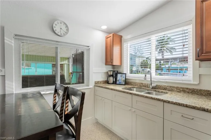Kitchen featuring light stone countertops