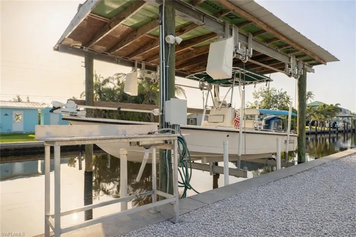 Dock area featuring boat lift and a water view
