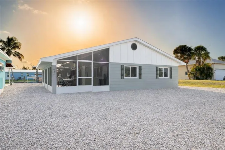 Back of house featuring a sunroom and board and batten siding