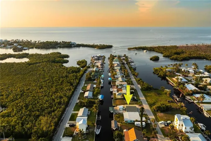Aerial view of property and surrounding area with a nearby body of water