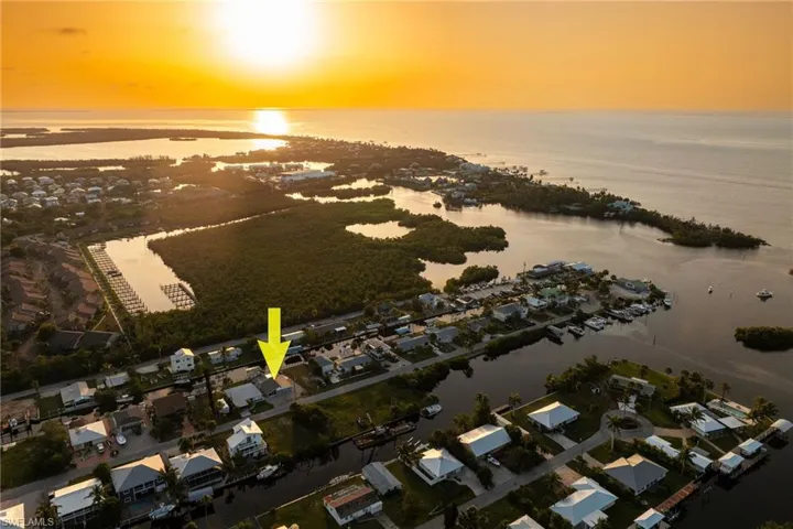 Aerial view at dusk of a water view and a residential view
