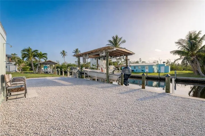 View of community featuring a dock, a water view, and boat lift