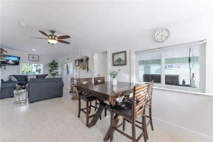 Dining area featuring a ceiling fan and dark speckled floor