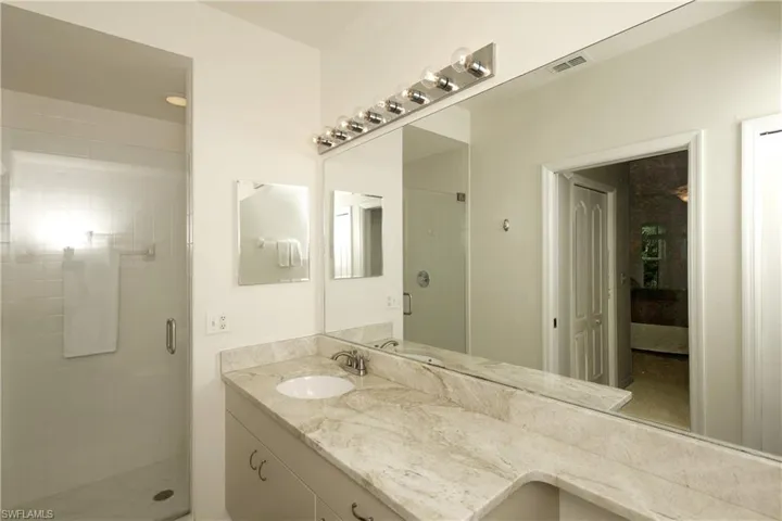 Primary bathroom with vanity and an enclosed shower
