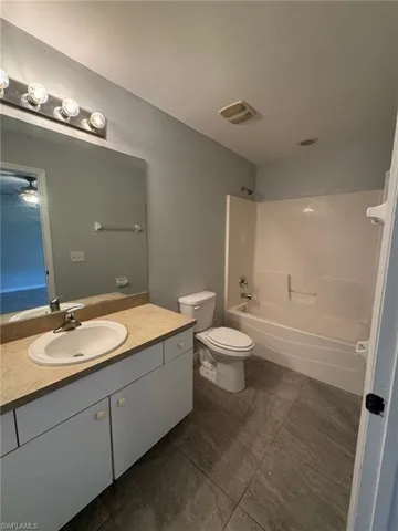 Bathroom with vanity and bathtub / shower combination