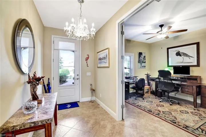 Foyer featuring a healthy amount of sunlight, ceiling fan, and baseboards