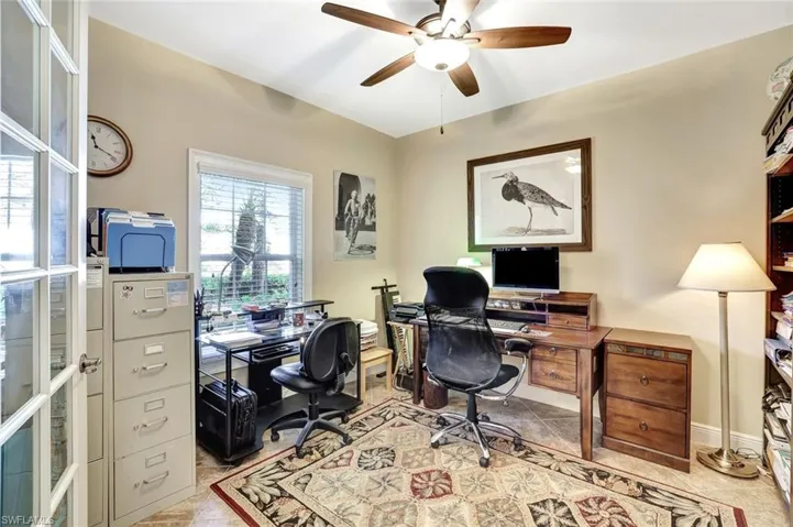 Tiled home office with baseboards and a ceiling fan
