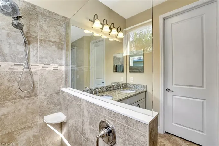 Bathroom featuring vanity and a walk in shower
