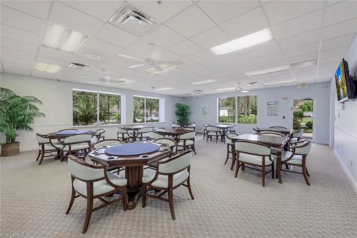 Dining room featuring light colored carpet, visible vents, and a drop ceiling