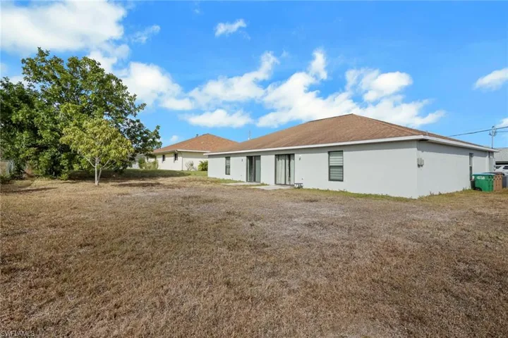 Rear view of house featuring stucco siding