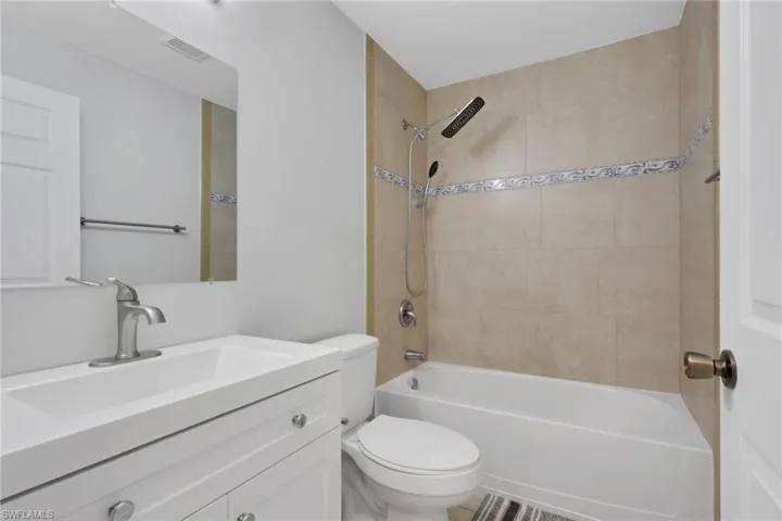 Full bath with vanity and shower / tub combination