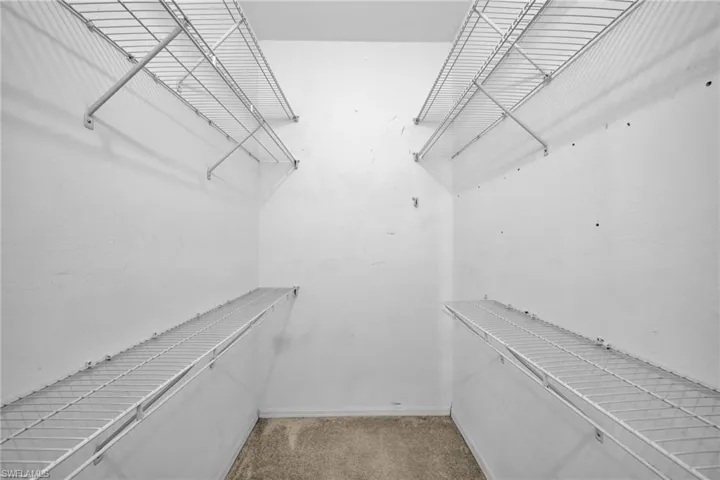 Spacious closet with carpet floors