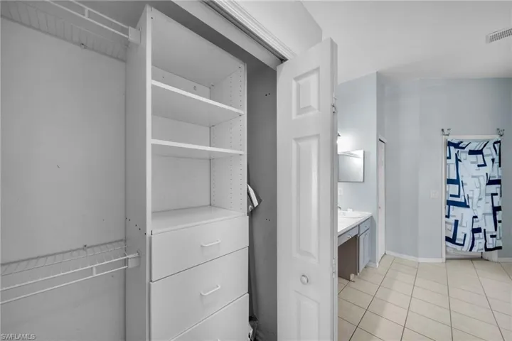 Spacious closet with light tile patterned flooring