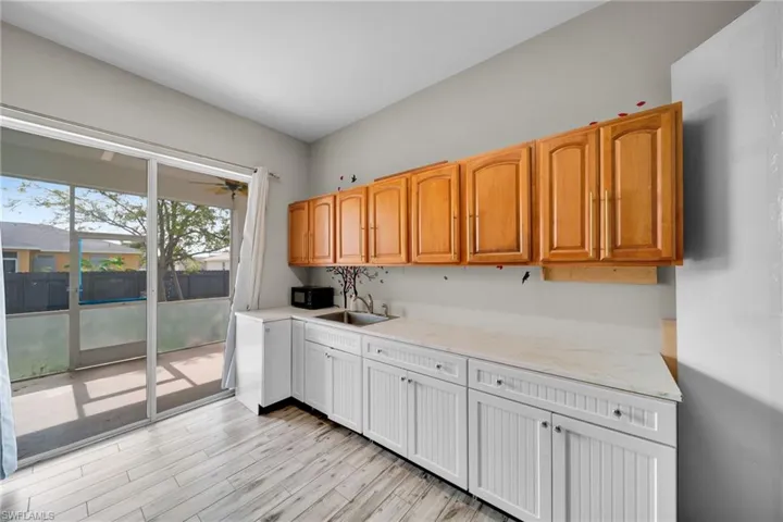 Kitchen with a sink and light wood-style floors