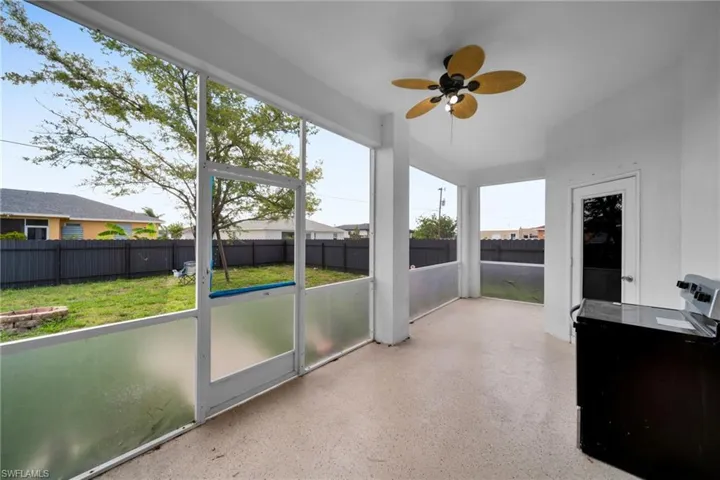 Unfurnished sunroom with ceiling fan