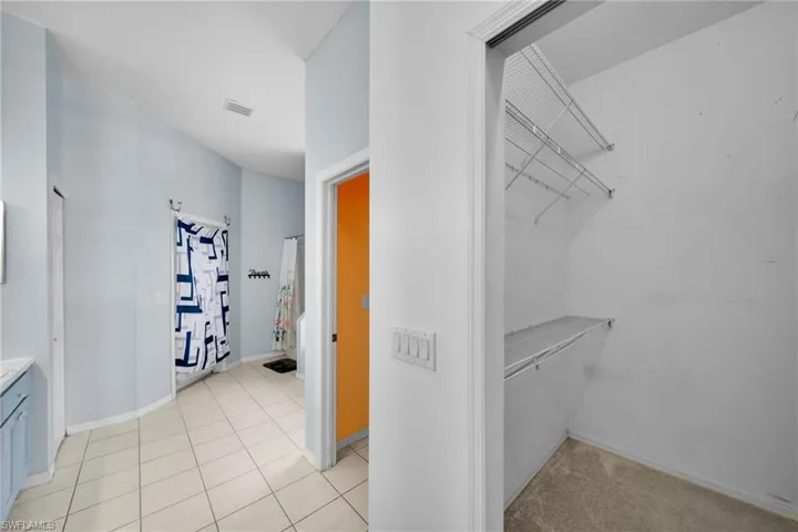 Spacious closet featuring light tile patterned floors