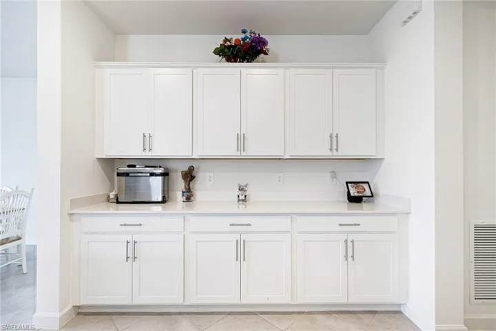 Bar featuring baseboards and light tile patterned floors