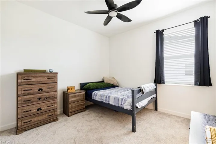 Bedroom featuring light carpet and ceiling fan